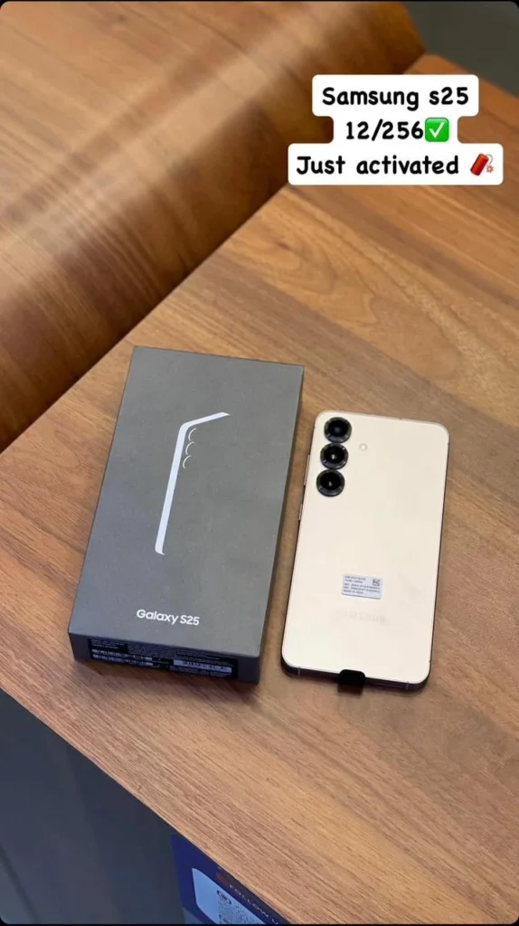 A samsung galaxy S24 Ultra smartphone in its box placed next to the black retail packaging.