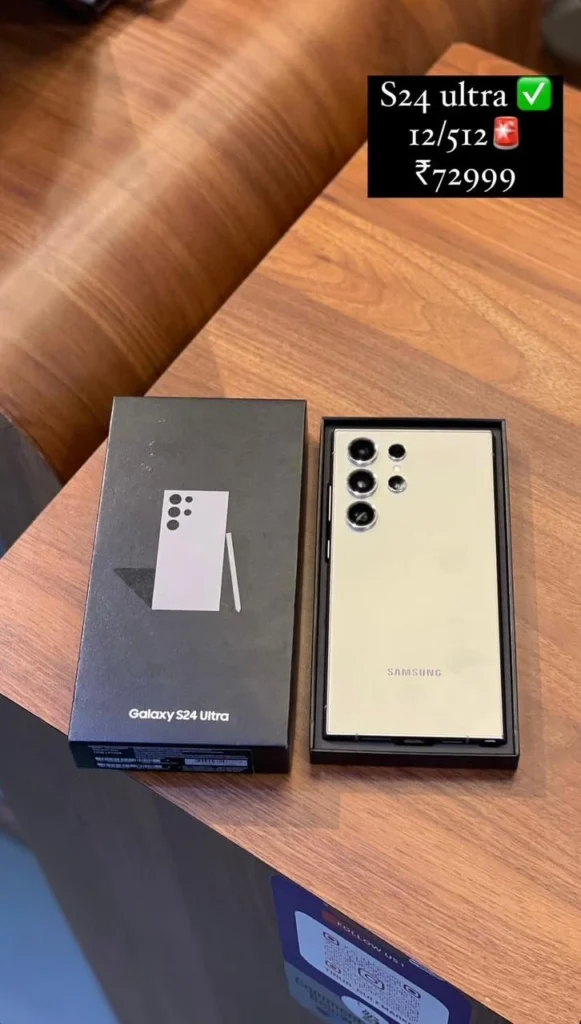 A samsung galaxy S24 Ultra smartphone in its box placed next to the black retail packaging.