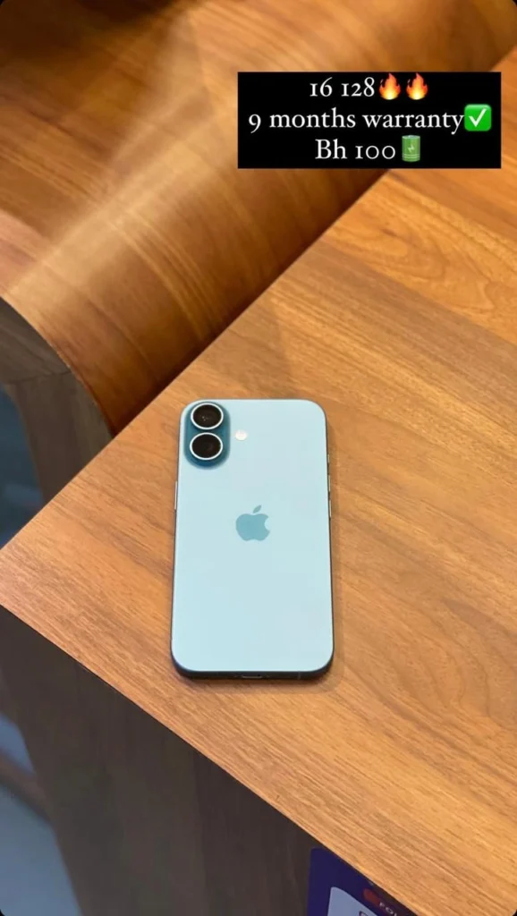 A blue smartphone with dual cameras placed on a wooden surface